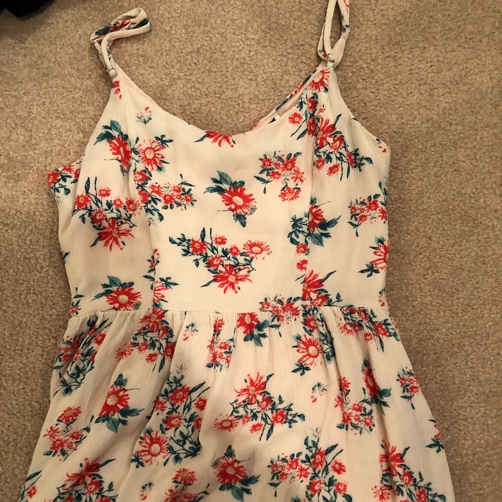 A cream and floral printed sun dress